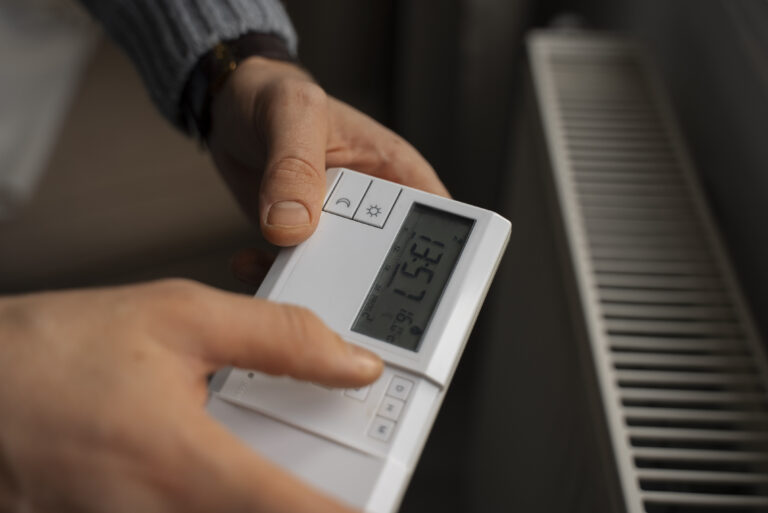 man-turning-off-thermostat-energy-crisis