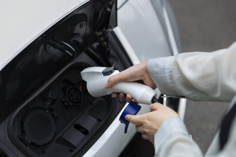 woman-charging-her-electric-car-station